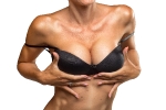 Close up of breast of attractive girl presenting her bra. Woman in underwear. Women body. Bra model. Plastic surgery. Female breast. Women body shape. Breast boobs, woman after plastic surgery. 